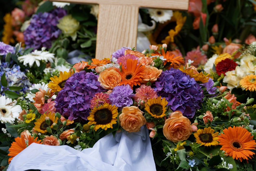 flowers and funeral wreaths on a grave