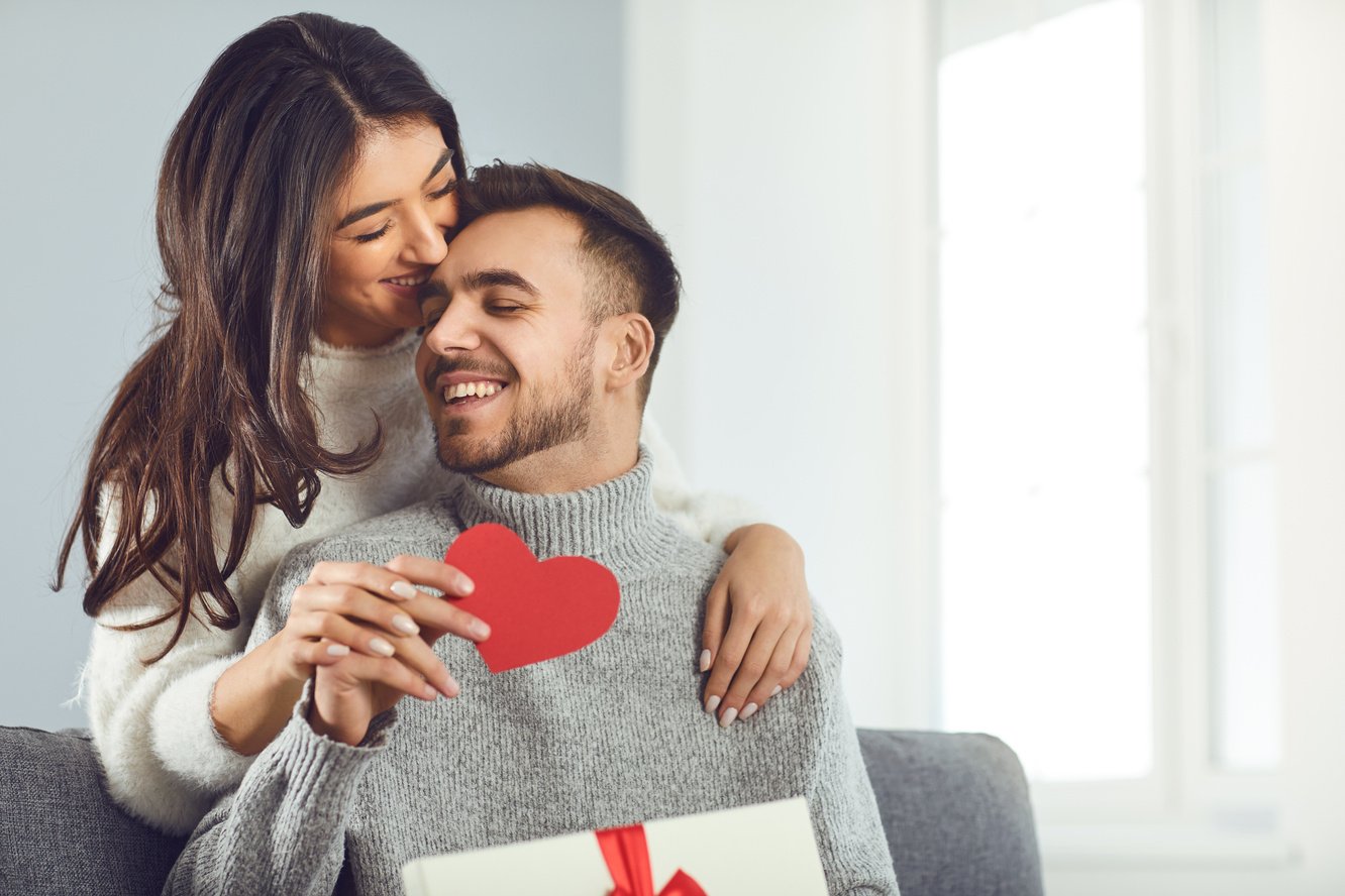 Valentine's day. Couple gives heart to the Valentine's Day in the room.